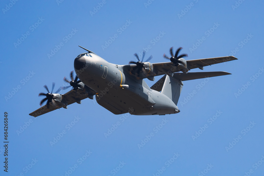 Fototapeta premium Untitled military transport plane at air base. Airport and airfield. Air force and army flight operation. Aviation and aircraft. Air lift. Military industry. Fly and flying.