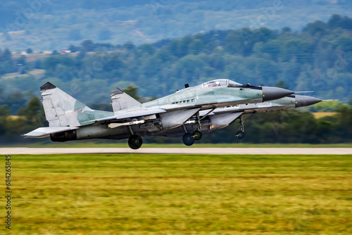 Military fighter jet plane at air base. Airport and airfield. Air force flight operation. Aviation and aircraft. Air defense. Military industry. Fly and flying. © Jozsef