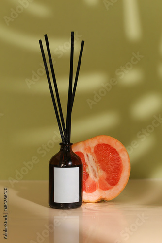 Citrus Zest Aromatherapy: Solo Organic Essential Oil Diffuser with Wooden Sticks, Lush Green Background Infused with the Grapefruit Citrus. Captivating Display Provides Ideal Space for Custom Labeling