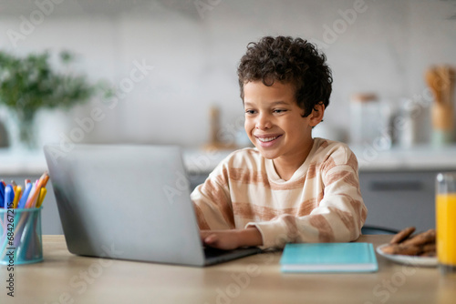 Distance Learning. Smiling Preteen Black Boy Study With Laptop At Home