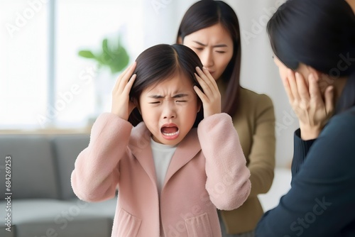 Asian girl cried sadly when her parents scolded her and screamed photo
