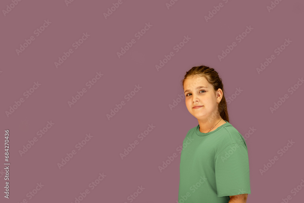 A beautiful teenage girl poses against a purple wall. Summer concept. The style of the Zoomer generation. The concept of social networks A beautiful teenage girl poses against a purple wall. Summer concept. The style of the Zoomer generation. The concept of social networks