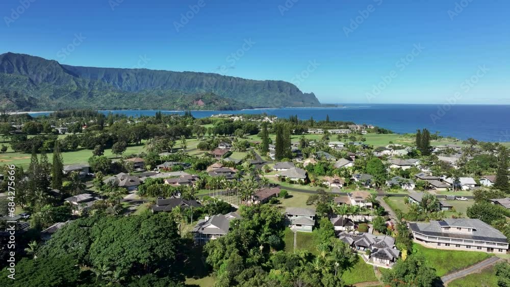 Aerial luxury golf club homes Hanalei bay mountain 1. Expensive luxury homes, resort, condominium and golf club. Recreation and tourism. Green landscape. Economy tourism based. Tourist warmth. Aerial luxury golf club homes Hanalei bay mountain 1. Expensive luxury homes, resort, condominium and golf club. Recreation and tourism. Green landscape. Economy tourism based. Tourist warmth.