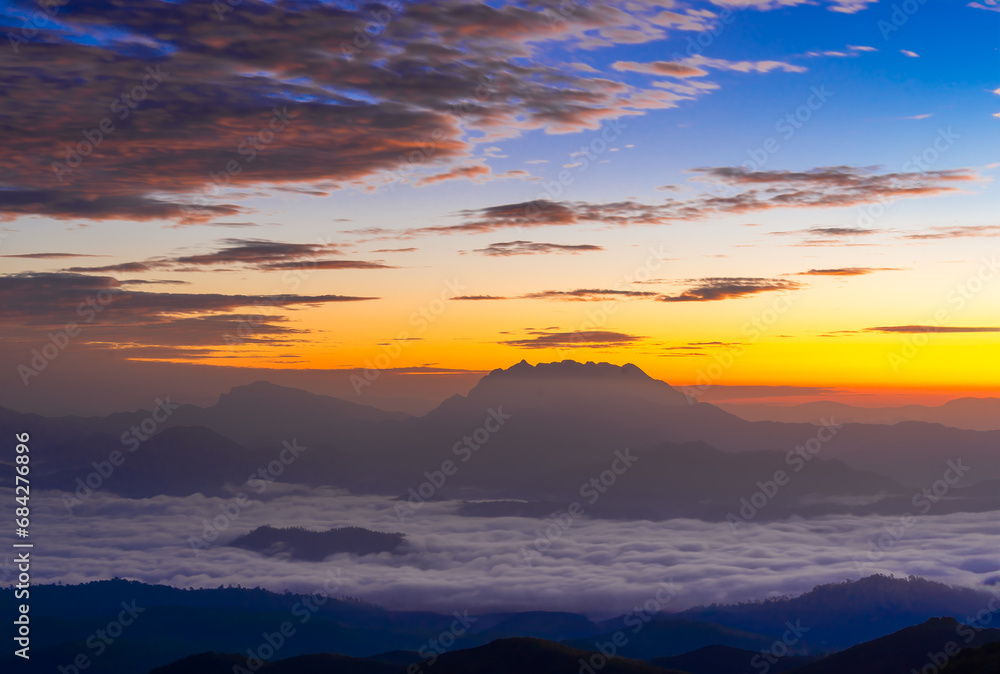 Mountain and sea of fog sunrise surrounded with mountain and forest at Huai Nam Dang National Park. The Spectacular sea of mist and Doi Luang Chiang Dao mt. in Chiang Mai, Thailand