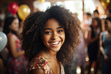Young smiling girl at festive party glowing with happiness and elegance among friends