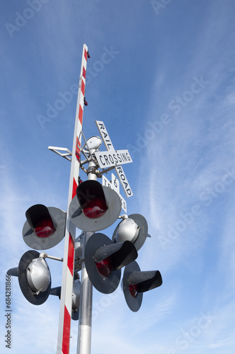 Railroad Crossbuck With A Partly Cloudy Sky - 6 Tracks