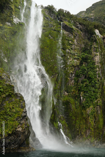 waterfall in the fjords of milford sound, new zealand
