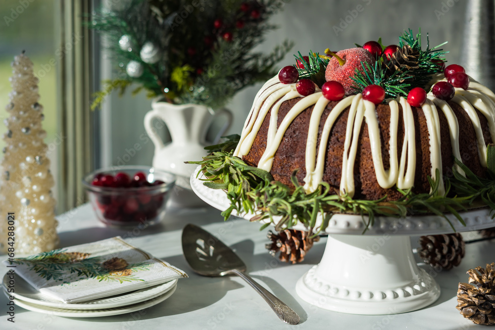A holiday decorated bundt cake next to a bright sunny window. A holiday decorated bundt cake next to a bright sunny window.
