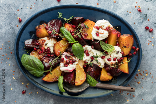 Roasted beets with burrata cheese on a platter, ready for serving. photo