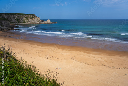 Playa de Langre is a sandy beach, perfect for sunbathing, surrounded by cliffs by the Cantabrian sea, Cantabria, Spain
