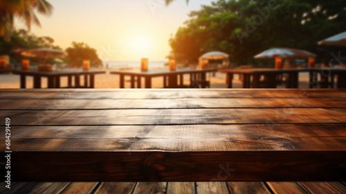 Concept of advertising image for product. Wooden table with blurred background located next to the beach. In the background and spectacular sunset