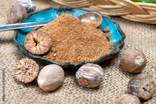 Tasty winter spice whole dried and ground powder nutmeg, used as an ingredient in many dishes, eggnog, potato, mulled wine