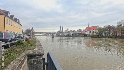 Regensburg with the Danube at flooding with a view of the cathedral and the stone bridge photo