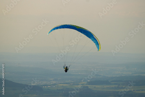 paraglider in the sky with a wide view during the sunset