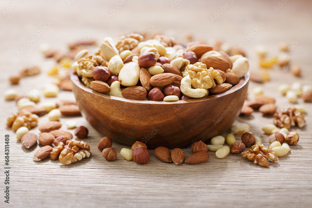 bowl of mixed nuts on wooden table bowl of mixed nuts on wooden table