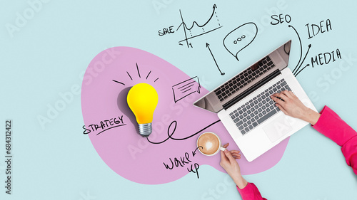 Creative workplace with strategy, laptop, yellow light bulb and plan, top view. Successful business girl works on a laptop and drinks coffee, concept. Management and workflow. Growth and start up