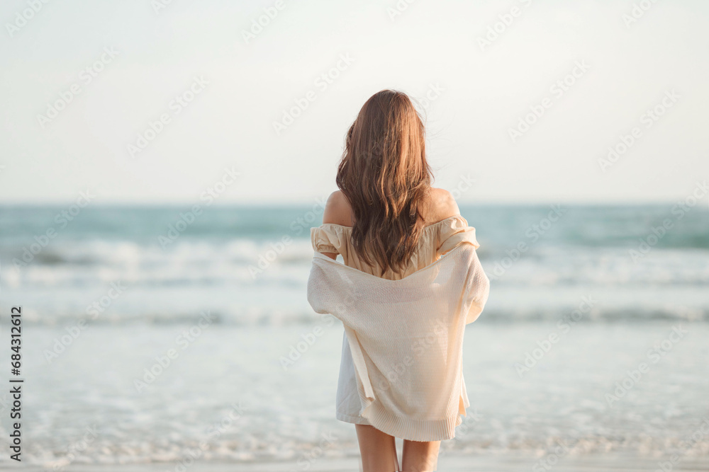Summer beach vacation concept, Young woman enjoying looking view of beach ocean on hot summer day Summer beach vacation concept, Young woman enjoying looking view of beach ocean on hot summer day
