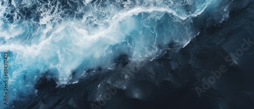 Black sand with blue ocean clear water , aeriel view ,dark atmosphere   photo