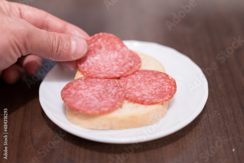 Making a sandwich with sausage