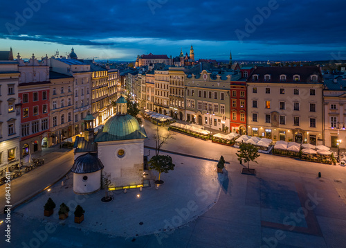 Main Square, St Adalbert church and Grodzka street illuminated in the night, Krakow, Poland