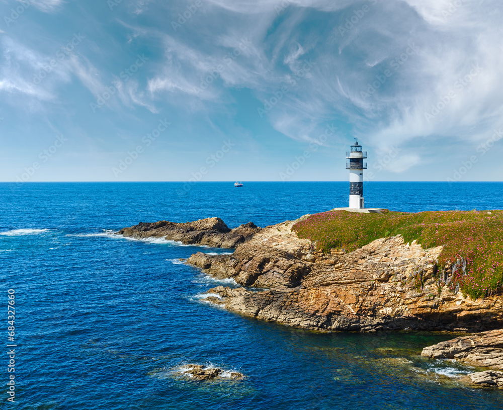 Summer ocean island Pancha coastline landscape with lighthouse (Spain).