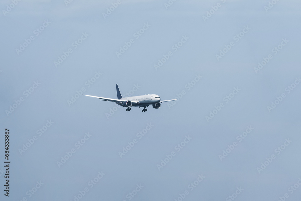 Airplane in flight on background of blue sky Airplane in flight on background of blue sky