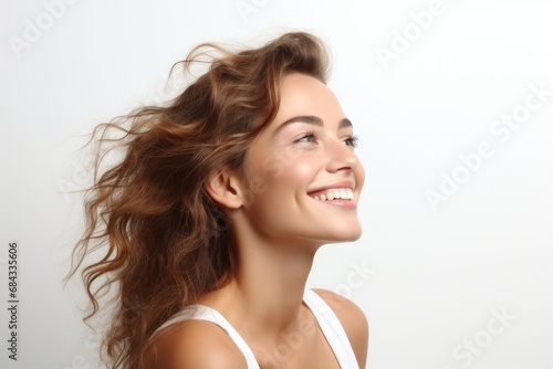 Beautiful happy woman on a white background looking to the side