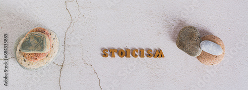 Fototapeta Naklejka Na Ścianę i Meble -  Concept stoicism word made from letters and stones on gray background top view web banner