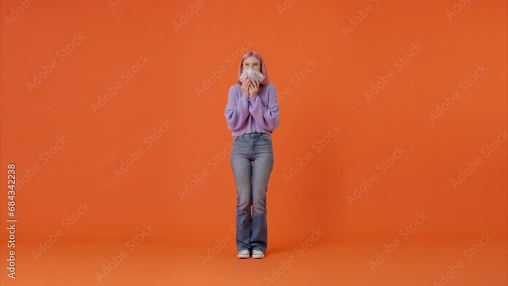 Joyful female counting and sniffing dollars indoors Joyful female counting and sniffing dollars indoors