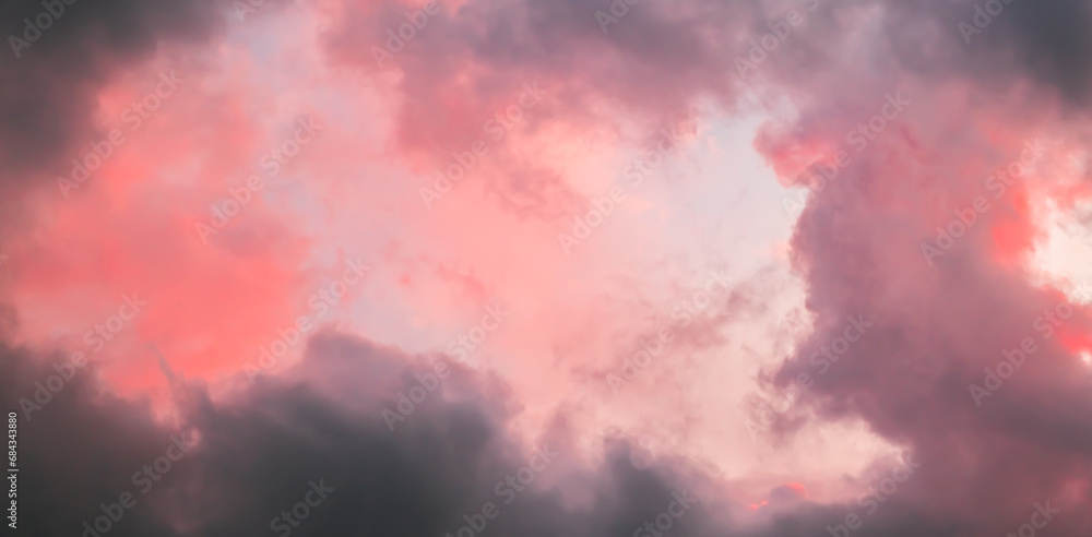 Pink sky with stormy clouds. Sunrise clouds are in vanilla colours. Beauty in nature. Details of evening sunset. Natural abstraction. Tension concept. Panoramic view. After thunderstorm