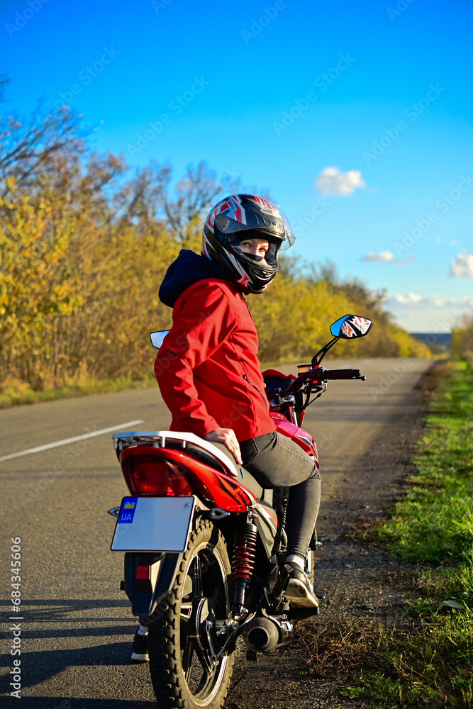 biker girl in red. red motorcycle. biker girl in red. red motorcycle.