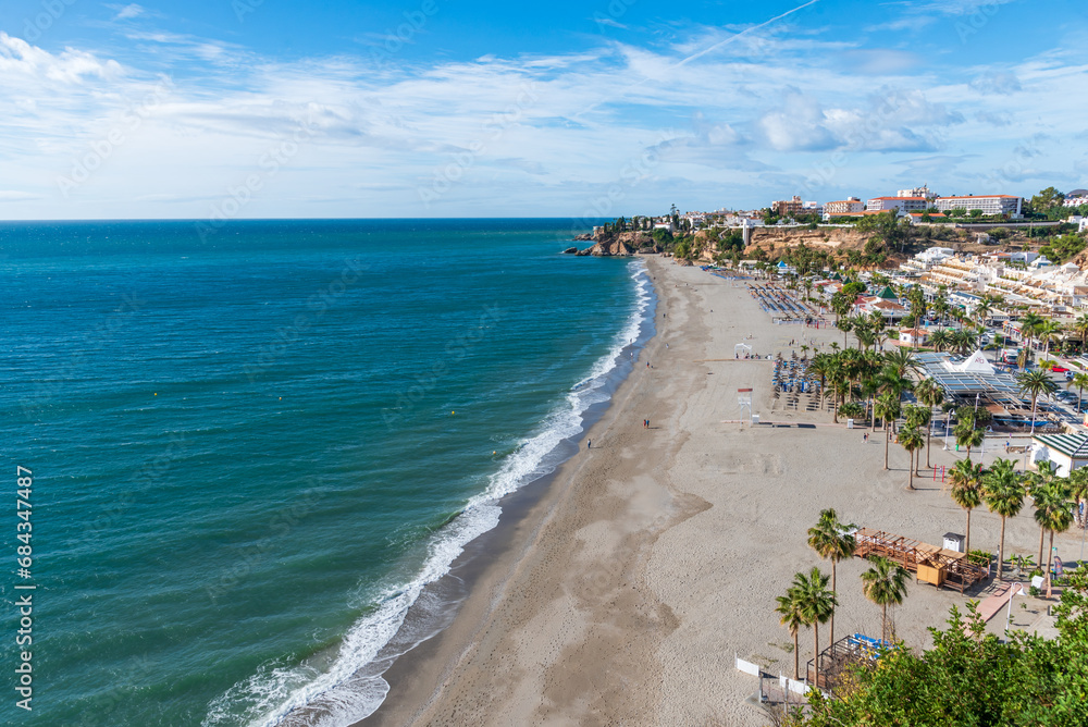 Burriana beach with the Balcón de Europa and part of the old town of Nerja in the background, Malaga.