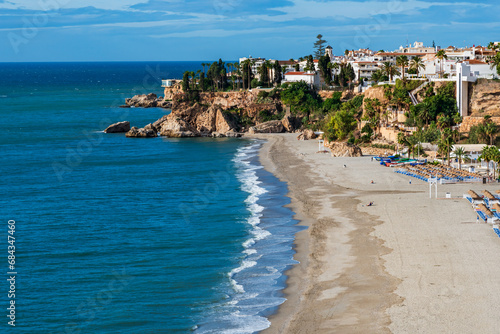 Burriana beach with the Balcón de Europa and part of the old town of Nerja in the background, Malaga. photo