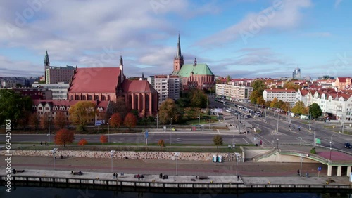 Szczecin from a bird's eye view on a sunny day. View of the city from the Oder River. City buildings, the seaport in Szczecin and its most characteristic places.