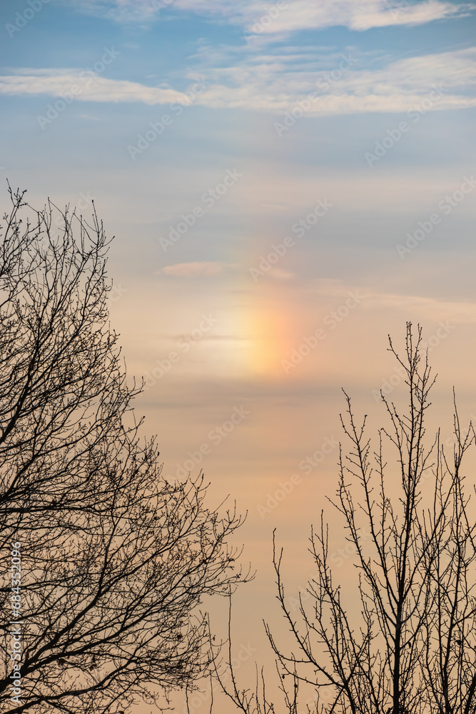 Obraz premium A parhelion (plural parhelia) - atmospheric optical phenomenon that consists of a bright colored spot in the sky. Other names: sun dog (or sundog) or mock sun, halo
