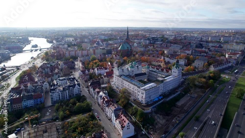 Szczecin from a bird's eye view on a sunny day. View of the city from the Oder River. City buildings, the seaport in Szczecin and its most characteristic places.