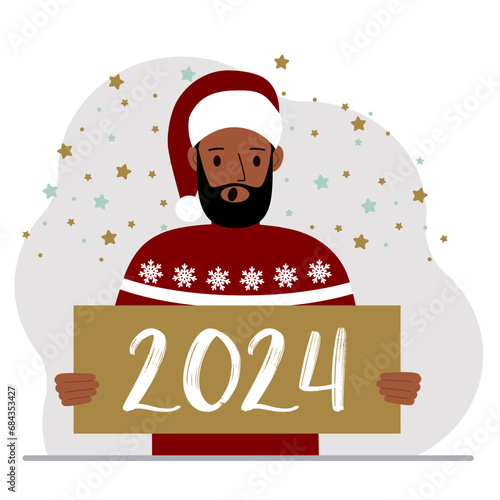 A man in a Christmas red hat with snowflakes holds a Happy New Year 2024 card.