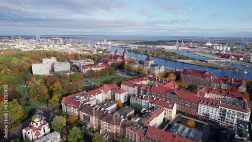 Szczecin from a bird's eye view on a sunny day. View of the city from the Oder River. City buildings, the seaport in Szczecin and its most characteristic places.