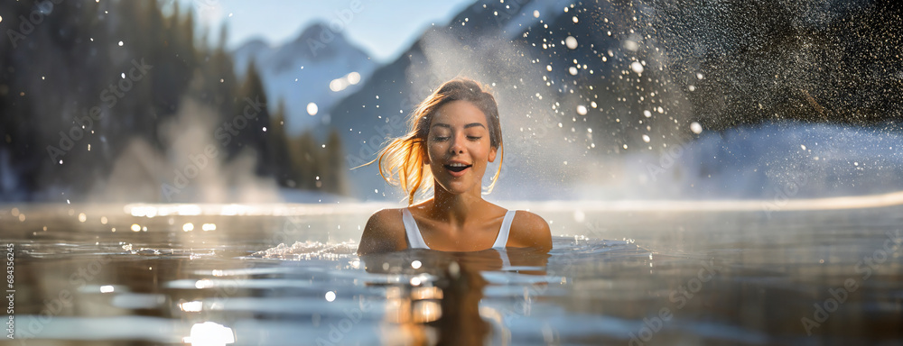 Young woman hardening the body, cold water therapy. Girl in bikini plunges into icy water in frozen lake ice hole. Boost the immune system and improve mental health. - obrazy, fototapety, plakaty 