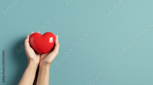 Hands Hold A Red Heart on the Minimalist Background
