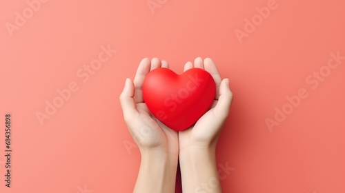 Hands Hold A Red Heart on the Minimalist Background 