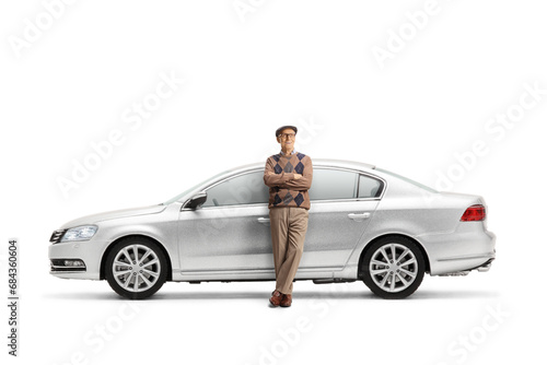 Elderly man leaning on a silver car
