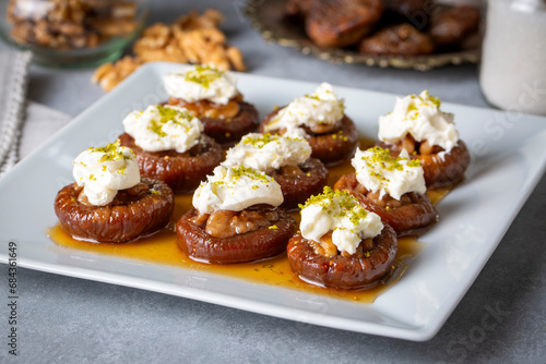 Stuffed dry fig dessert, cooked with syrup, traditional, pistachio and kaymak (Turkish name; kaymakli incir tatlisi )
