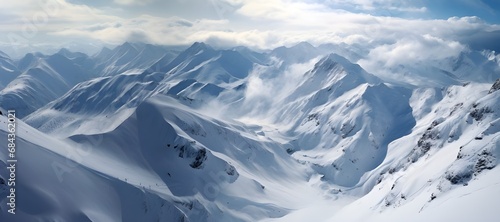 Aerial view of snow covered mountains in winter. Ski resort in the alps. 