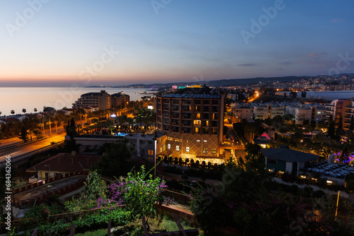 View of Avsallar city at sunset in Turkey and hotels with tourists.