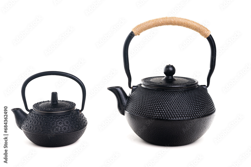 Two traditional cast iron teapots on white background. Two traditional cast iron teapots on white background.