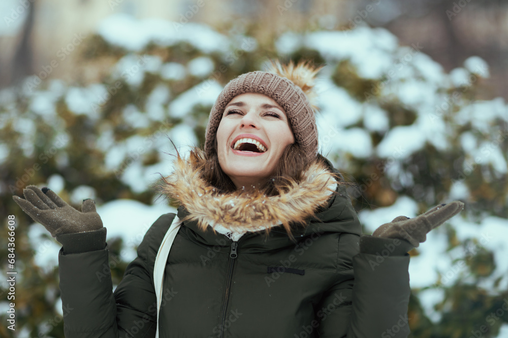 smiling modern woman outdoors in city park in winter smiling modern woman outdoors in city park in winter