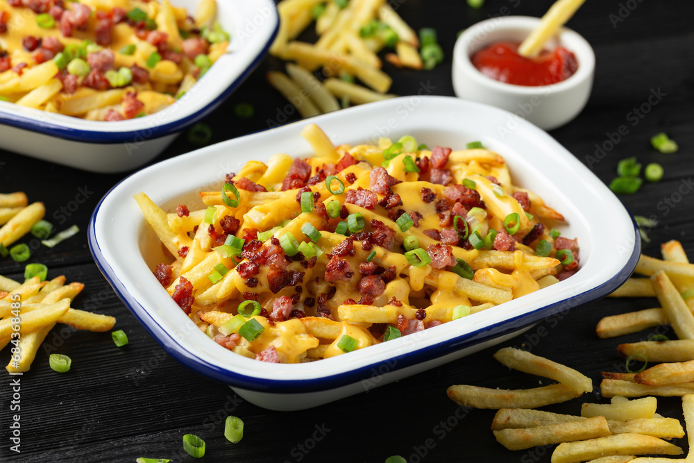 Crispy French fries loaded with bacon, cheese sauce and spring onion Crispy French fries loaded with bacon, cheese sauce and spring onion
