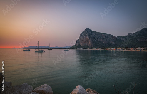 Sunrise on the paradise Tyrrhenian sea bay. San Vito lo Capo and Monte Monaco in far, Sicily, Italy. June 2023, Panoramic picture photo