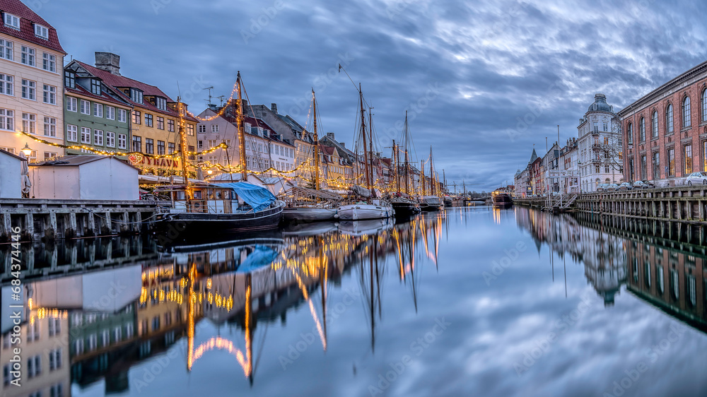 Blue hour i Copenhagen with christmas decorations reflecting in the water